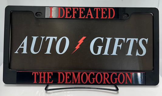BLACK METAL LICENSE PLATE FRAME WITH I DEFEATED THE DEMOGORGON